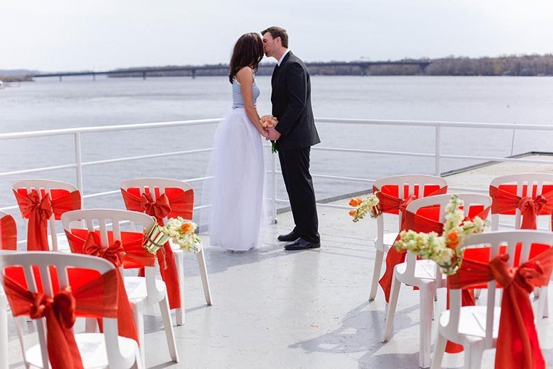 Bride and Groom kissing on ship deck.